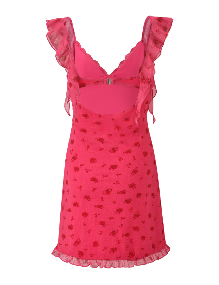 The AMARIS MINI DRESS - DITSY FLORAL by TIGERMIST features a sleeveless pink V-neck design with a sheer floral mesh overlay, ruffled straps, back cutout, lace-trimmed hem, and a fitted silhouette.