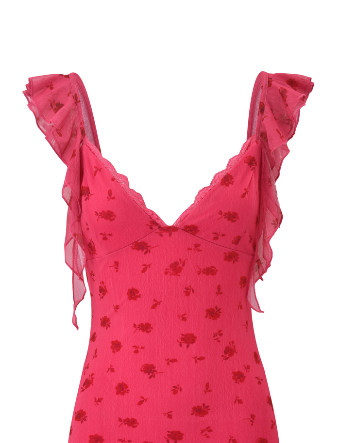 A close-up of the AMARIS MINI DRESS - DITSY FLORAL by TIGERMIST, featuring a pink V neck mini design with thin ruffled straps, red floral print, delicate lace trim, and airy, lightweight mesh fabric.
