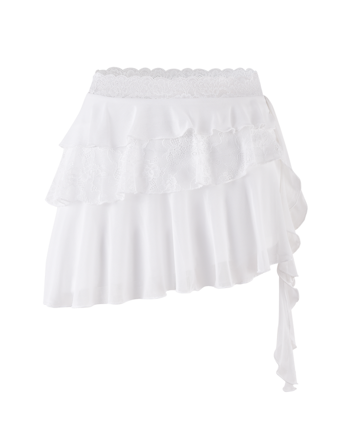 The TIGERMIST AVALYN SKIRT in white features an asymmetrical high-waisted design with layered ruffles, delicate lace trim, and a flowing fabric. Its uneven hemline creates a unique and charming look.