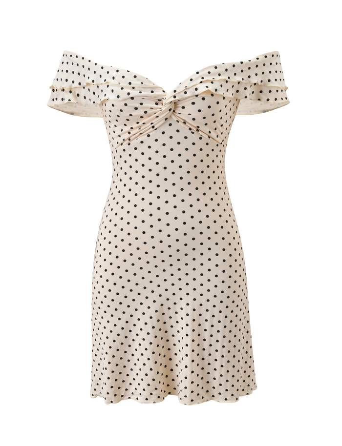 The DENALI MINI DRESS - CREAM DOT by TIGERMIST features an off-the-shoulder design, fitted silhouette, knot detail at the bust, and playful black polka dots for a chic mini look.