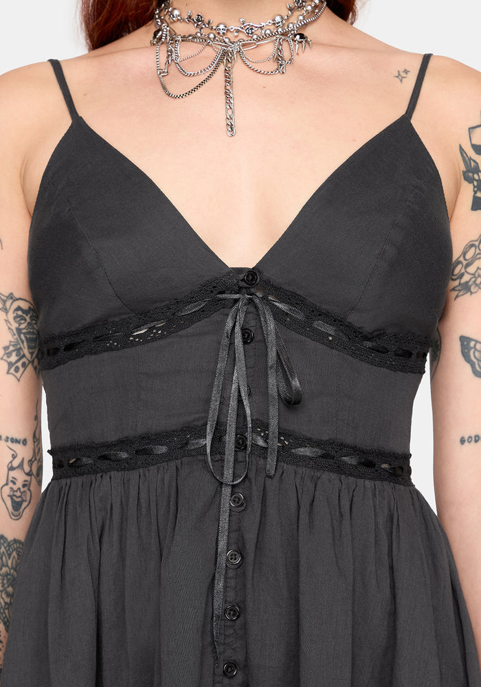grey dress with lace details and buttons, worn by a person with tattoos.