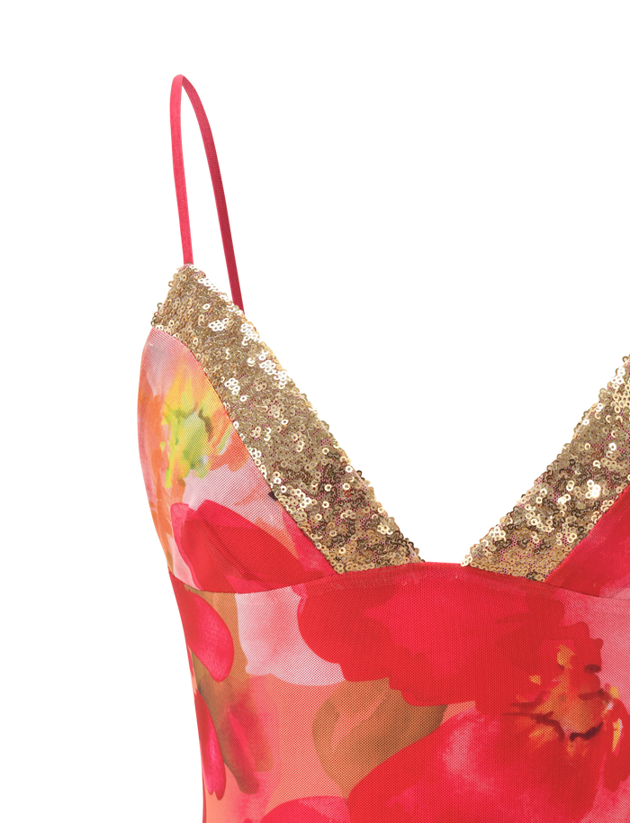Close-up of the FENELLA TOP - DAIQUIRI FLORAL by TIGERMIST, a cami top with thin red straps, featuring a vibrant red and pink floral pattern and a V-shaped bust trimmed with gold sequins.