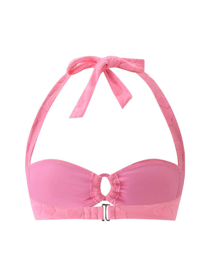 The TIGERMIST FIORA BIKINI TOP in baby pink features textured halter straps, a front clasp, adjustable neck tie, and a subtle floral band pattern, shown against a pink background.