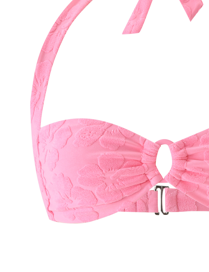 A close-up of the TIGERMIST FIORA BIKINI TOP in baby pink, showcasing its floral texture, halter straps, and a silver front clasp.