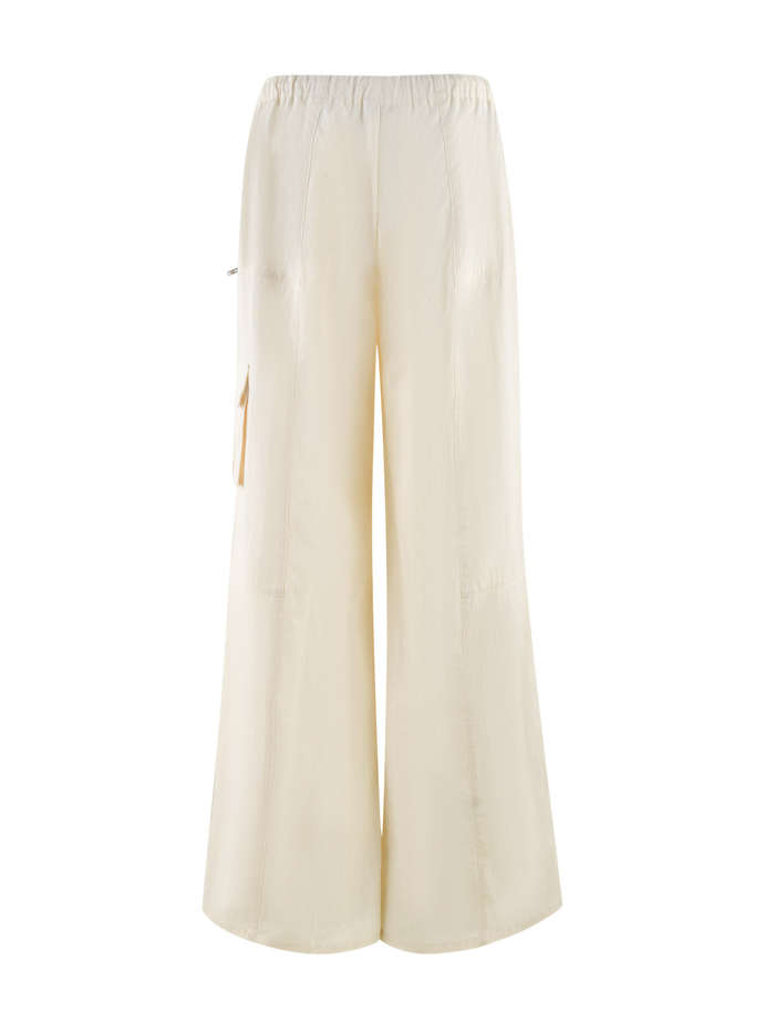 The TIGERMIST HERMIONE PANT in Soft Butter features a wide-leg, high-waisted design with an elastic waistband and side pocket, shown against a white background.