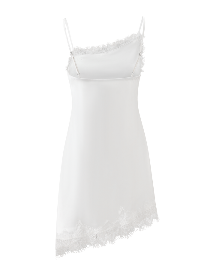 The ILARIA MINI DRESS by TIGERMIST features ivory satin, thin spaghetti straps, and scalloped lace trim along the asymmetrical hem and neckline, shown on a plain white background.