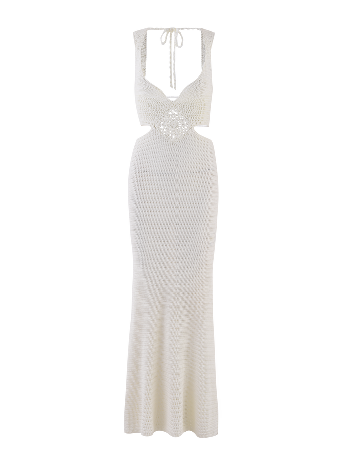 The JONAH MAXI DRESS in cream by TIGERMIST is a sleeveless crochet maxi with a deep V-neck, open back, bodycon fit, slight hem flare, and elegant diamond crochet detail.
