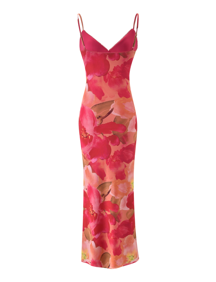 The JULIANNA MAXI DRESS - DAIQUIRI FLORAL by TIGERMIST is a vibrant floral print maxi dress with adjustable spaghetti straps and a bold red and pink pattern on a coral base.