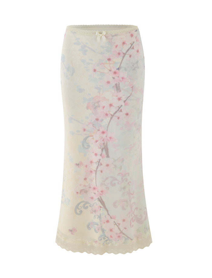 The TIGERMIST LONIE MIDI SKIRT in Neutral features a sheer cream mesh with exclusive pink and blue washed cherry blossom florals, lace trim at the hem and waistband, and a decorative bow at the waist.