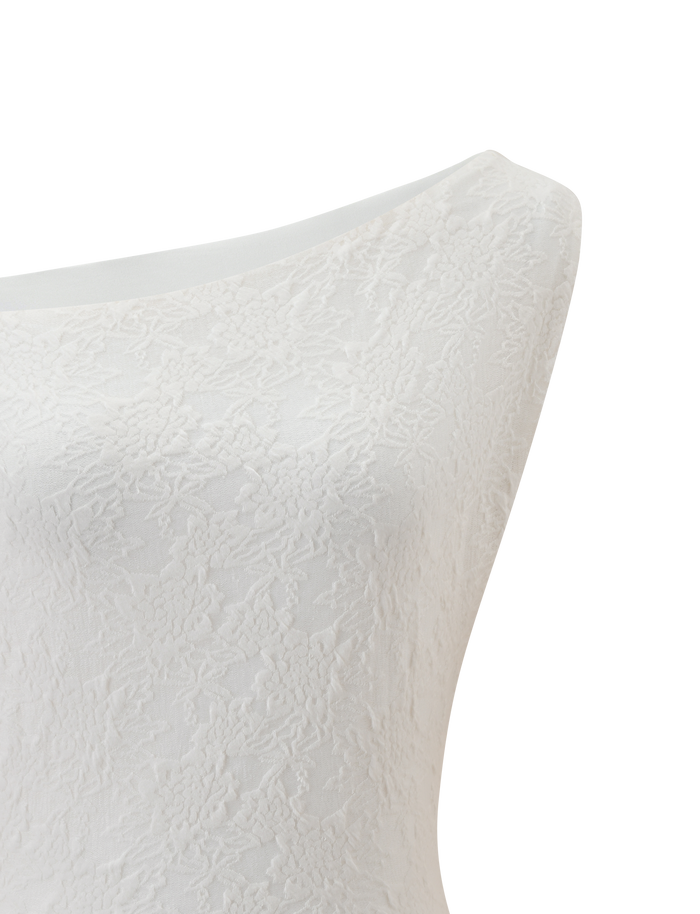 Close-up of the TIGERMIST MAVEN LACE TOP in ivory, featuring a subtle floral texture, displayed on a mannequin against a plain white background.