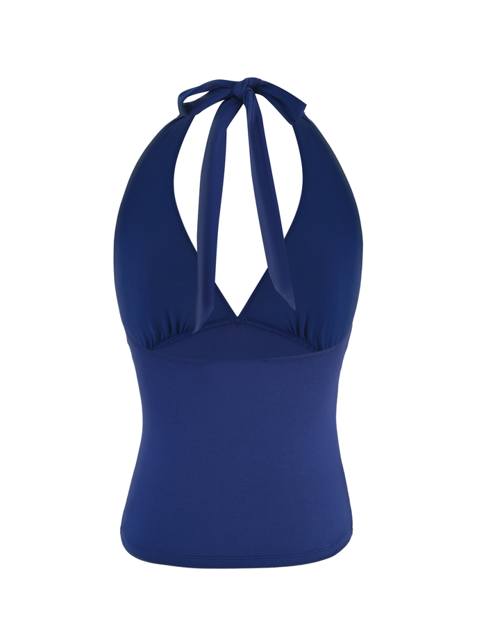 The MERIAL TOP by TIGERMIST is a fitted halter in denim blue with a deep V-neckline and neck tie, made from stretchy jersey fabric, shown on a white background.