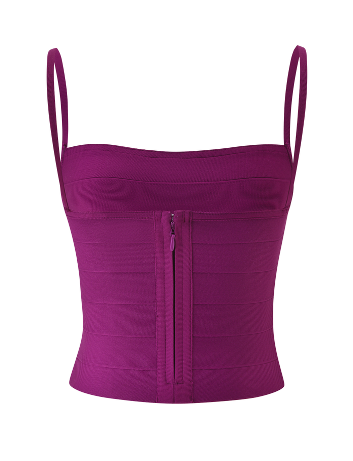The MIDORI BANDAGE TOP - PLUM by TIGERMIST is a purple, fitted crop top featuring a square neckline, thin shoulder straps, and a front zipper closure in a waist-cinching bandage tank style, displayed on a plain white background.
