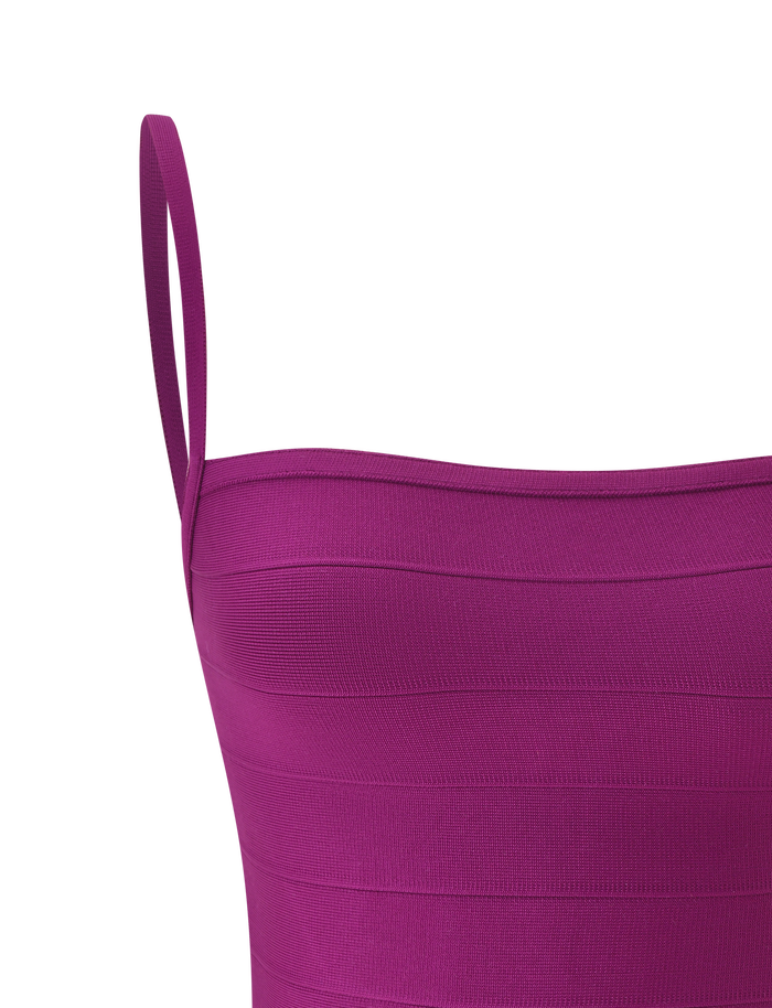 Close-up of the MIDORI BANDAGE TOP by TIGERMIST in plum—a sleeveless design featuring a square neckline, thin shoulder straps, and horizontal textured stripes—displayed against a light background. This waist-cinching top flatters the silhouette for a striking look.
