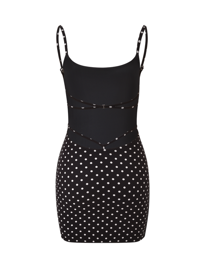 The TIGERMIST MINERVA MINI DRESS 2.0 in black polka dot features a fitted bodice, adjustable straps, thin waist detailing, and a sleeveless bodycon design with chic polka dots on the skirt and lower bodice.
