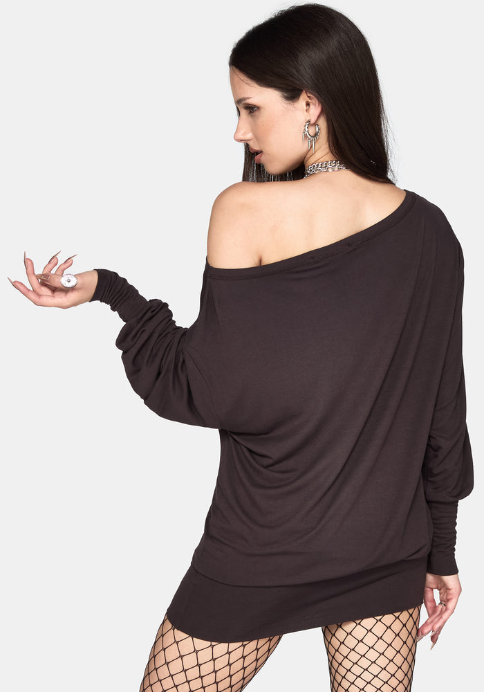 A woman modeling a grey off-the-shoulder long-sleeve mini dress with a draped silhouette, shown from a three-quarter back angle against a light gray background.
