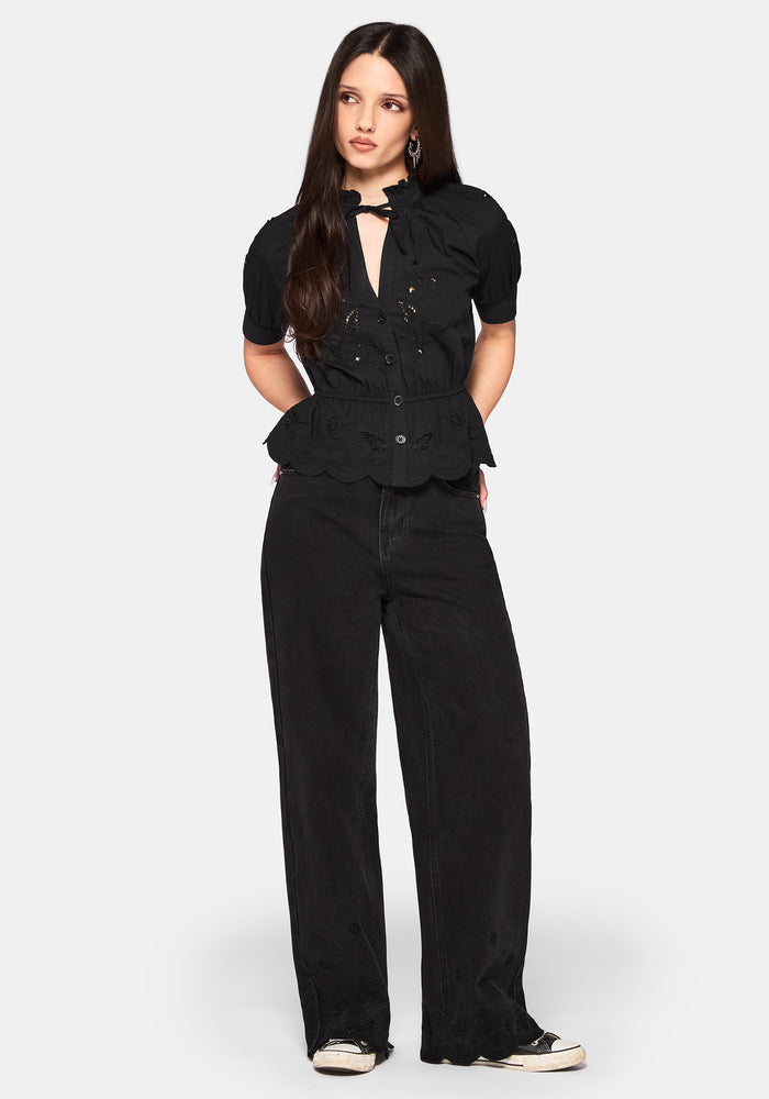 Woman wearing a black casual outfit on a white background