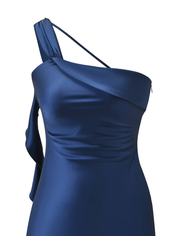 A close-up of the TIGERMIST RAINEY MINI DRESS in navy, showing its satin one-shoulder design with asymmetric thick and thin straps, draped bodice, and elegant waterfall ruffle details.