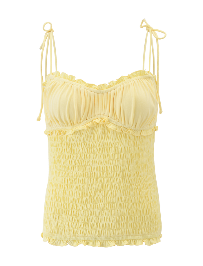 The SAFIRA TOP - LEMON by TIGERMIST is a light yellow camisole with ruched detailing, adjustable tie straps, a ruffled neckline, and a smocked, stretchy bodice for a flattering fit.