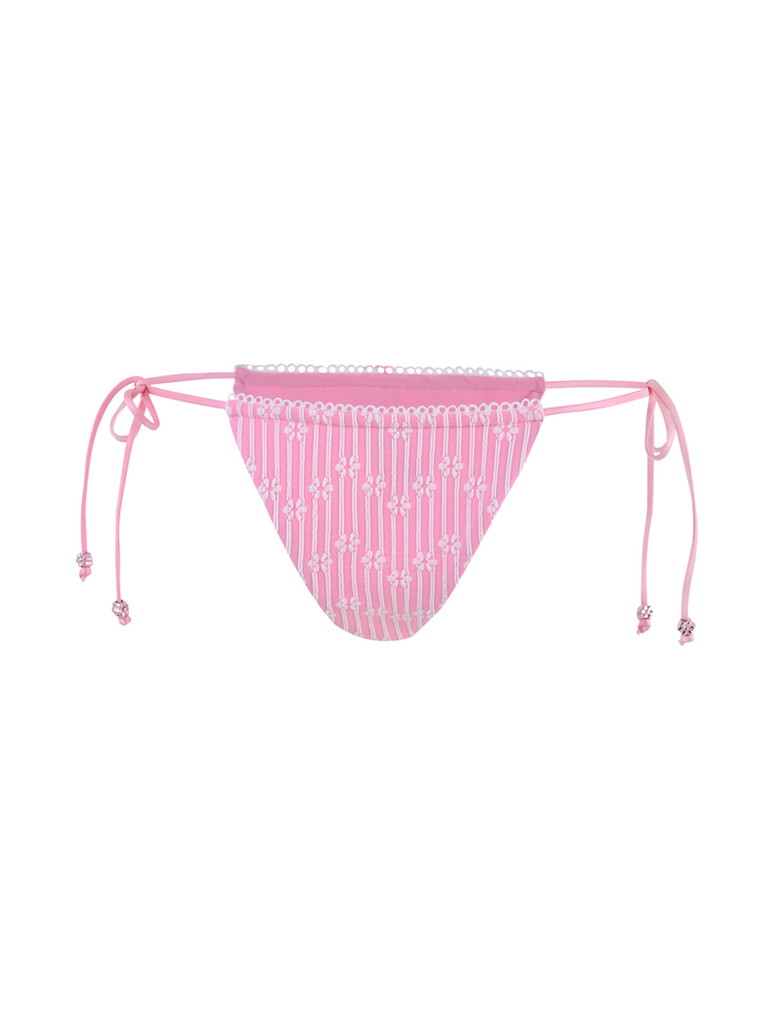 The SAHRA BIKINI 2PC BOTTOM - PINK FLOWER STRIPE by TIGERMIST features a pink ribbed fabric with white vertical dotted stripes and adjustable side ties, shown against a plain white background.