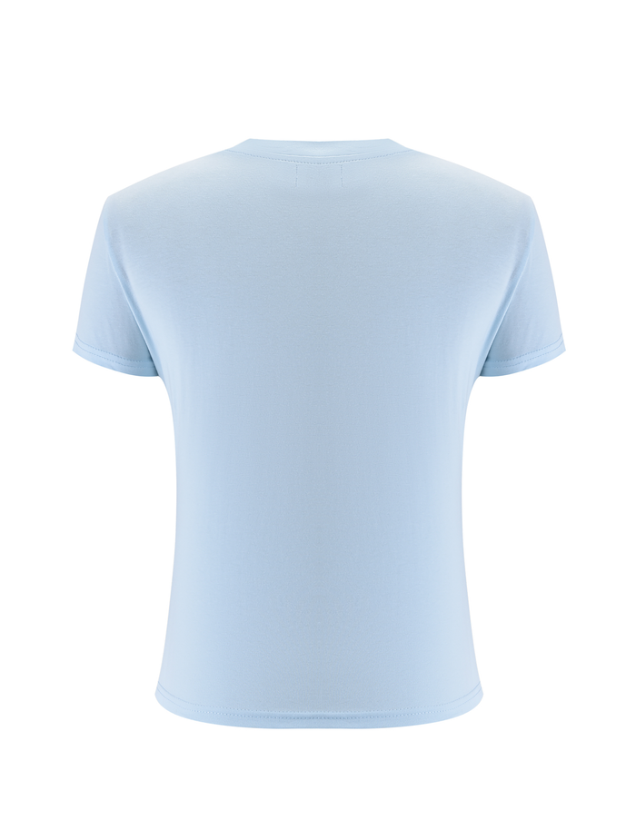 The SAPHIRA TEE by TIGERMIST is displayed from the back against a white background, featuring a plain design in light blue stretchy fabric.