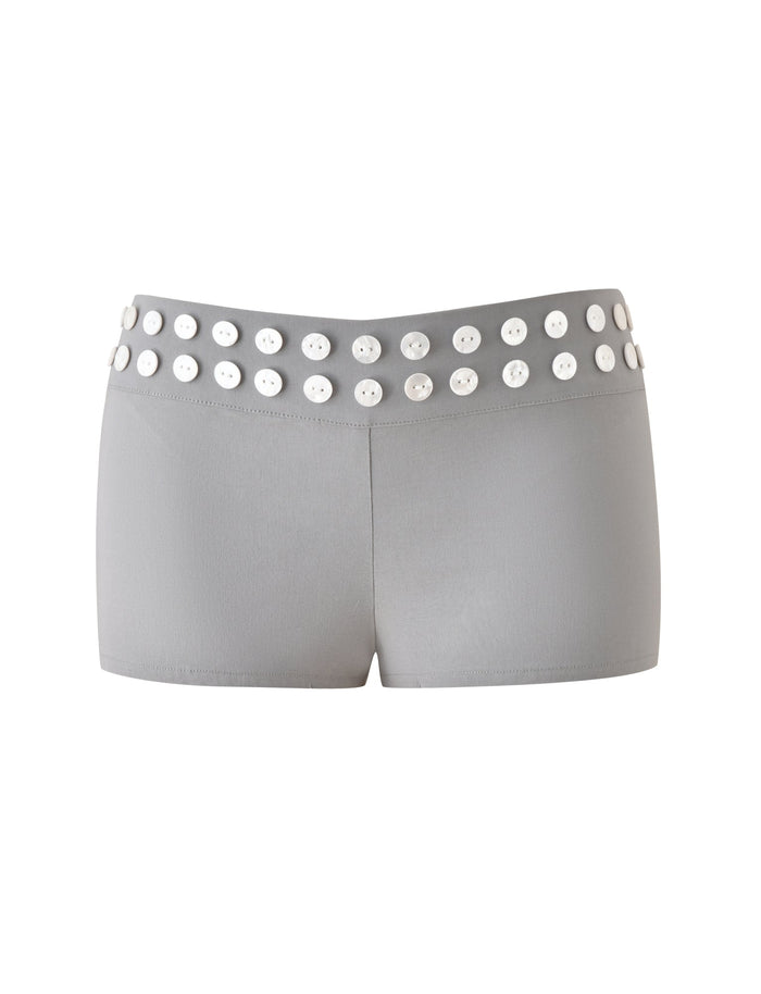 The SUKI SHORT - GREY by TIGERMIST showcases a tailored silhouette with a row of oversized faux shell buttons on the waistband, set against a white background.