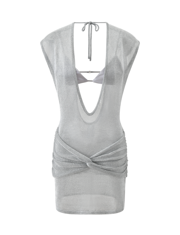 The TIGERMIST ZOSIA MINI DRESS in silver features a sheer knit, deep V-neck, open back tie closure, and twisted drop waist draping. A matching silver satin bralette adds a bold layered touch.